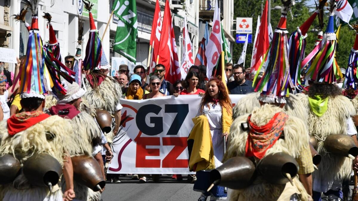 Demonstrators wear a traditional Basque shepherd costume, during a march in Hendaye, south-west France on August 24, 2019, against the annual G7 Summit. GEORGES GOBET / AFP