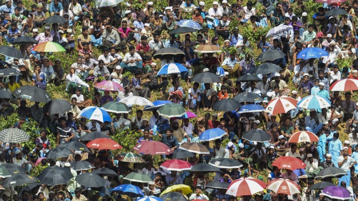 Rohingya refugees attend a ceremony organised to remember the second anniversary of a military crackdown that prompted a massive exodus of people from Myanmar to Bangladesh, at the Kutupalong refugee camp in Ukhia on August 25, 2019. MUNIR UZ ZAMAN / AFP