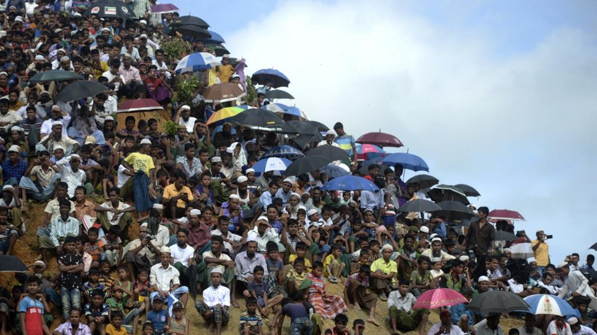 Rohingya refugees attend a ceremony organised to remember the second anniversary of a military crackdown that prompted a massive exodus of people from Myanmar to Bangladesh, at the Kutupalong refugee camp in Ukhia on August 25, 2019. MUNIR UZ ZAMAN / AFP