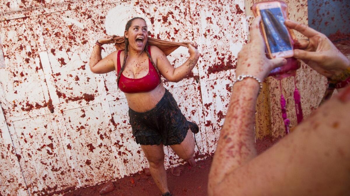 The iconic fiesta, which is billed at "the world's biggest food fight" has become a major draw for foreigners, in particular from Britain, Japan and the United States. JAIME REINA / AFP