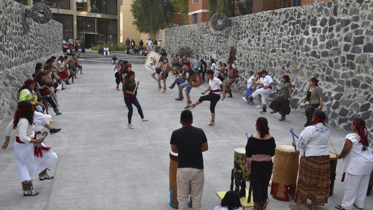 Dancers and players perform ahead of a pre-Columbian ballgame called "Ulama" -in Nahuatl indigenous language- which rule is to hit a "Ulamaloni" (solid rubber ball) with the hip or shoulder, at the FARO Poniente cultural center in Mexico City on August 21, 2019. ROCIO VAZQUEZ / AFP