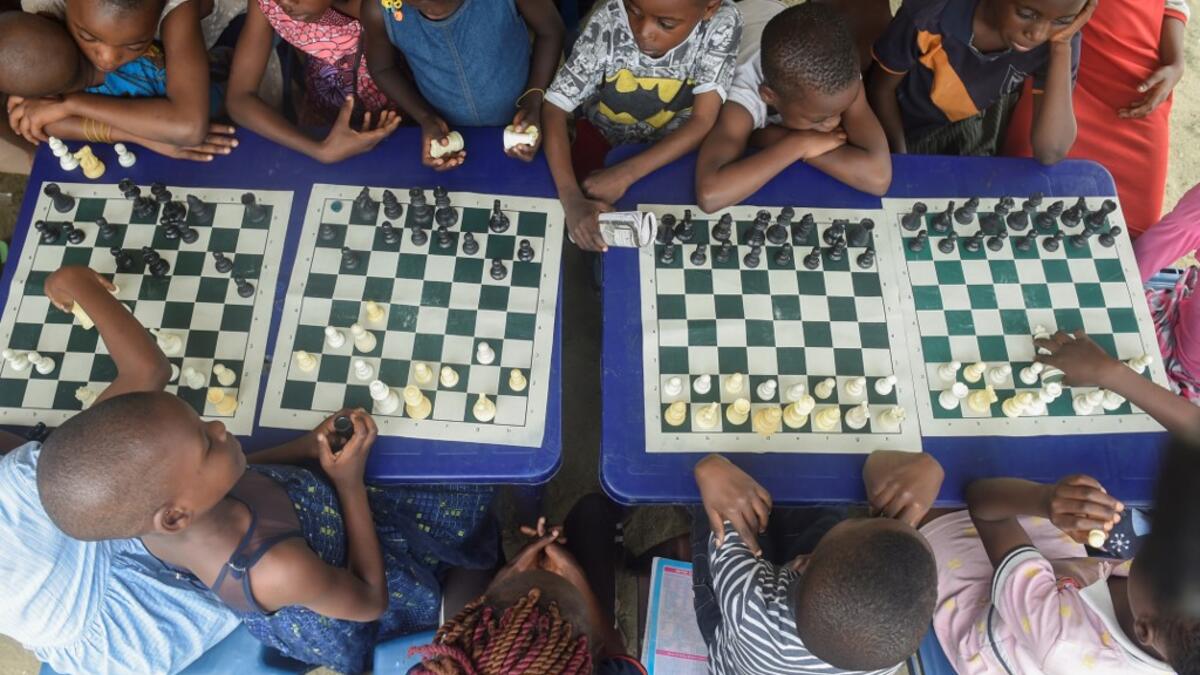They are thinking about the next move they will make, as part of a project that is supposed to bring hope to a slum in Nigeria's megapolis. While dozens of matches are played simultaneously, participants, some as young as three years old, practice this brain game often considered out of reach for the poor populations of Africa's most populous country. PIUS UTOMI EKPEI / AFP