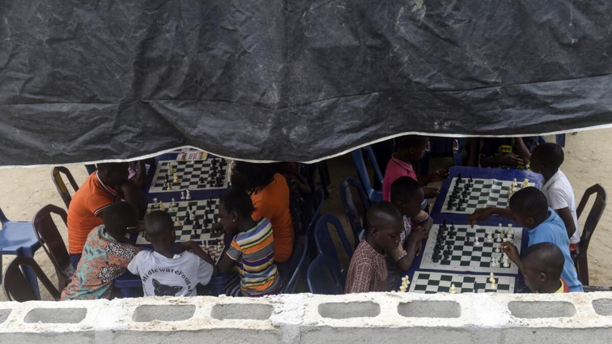 They are thinking about the next move they will make, as part of a project that is supposed to bring hope to a slum in Nigeria's megapolis.  PIUS UTOMI EKPEI / AFP