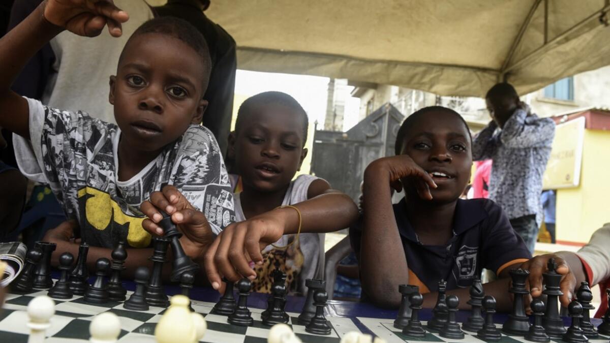 Children sit under a canopy as they play during a chess class at Ogolonto in Ikorodu district of Lagos  PIUS UTOMI EKPEI / AFP