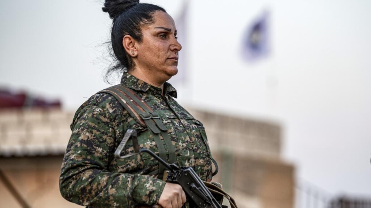 A member of the Bethnahrin Women Protection Forces (HSNB), an all-female Syriac-Assyrian paramilitary group under the umbrella of the Syrian Democratic Forces (SDF), lines up as the group commemorates the fourth anniversary of its creation, in the countryside of the town of Tall Tamr in the northwestern Syrian province of Hasakah, on August 30, 2019.  Delil SOULEIMAN / AFP