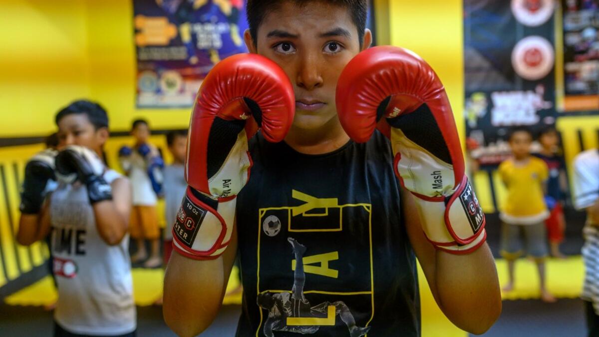 In this photograph taken on August 29, 2019, children from Muslim Uighur minority take part in a Muay Thai training session in Istanbul. BULENT KILIC / AFP