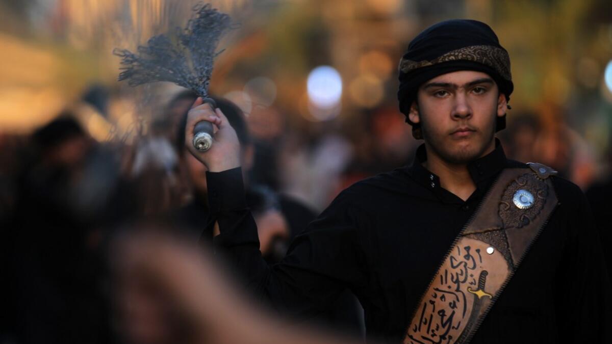Iraqi Shiite men beat their backs with metal chains in the capital Baghdad's mostly Shiite neighbourhood of Kadhimiya marking the 8th day of Muharram, ahead of Ashura. Ahmad AL-RUBAYE / AFP