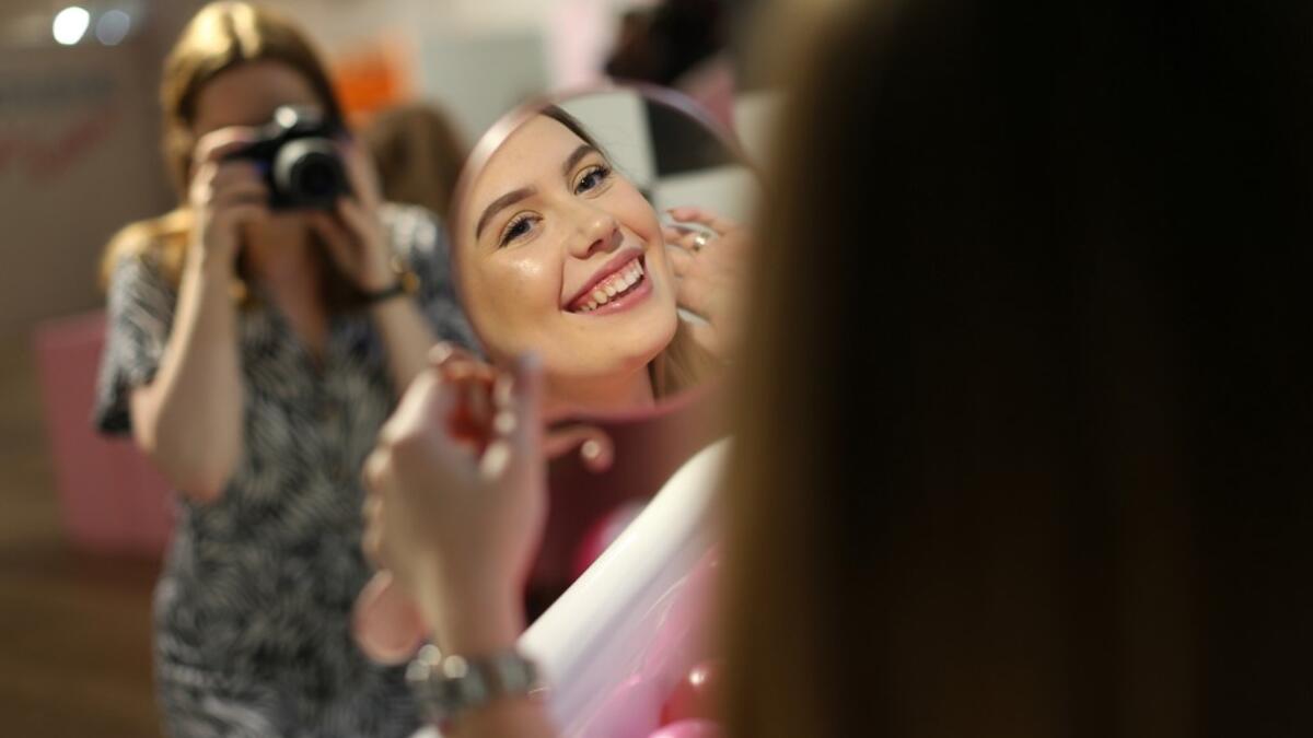 Visitors take and pose for "selfie" photographs at The Selfie Factory in Westfield London shopping centre in west London on September 11, 2019. ISABEL INFANTES / AFP