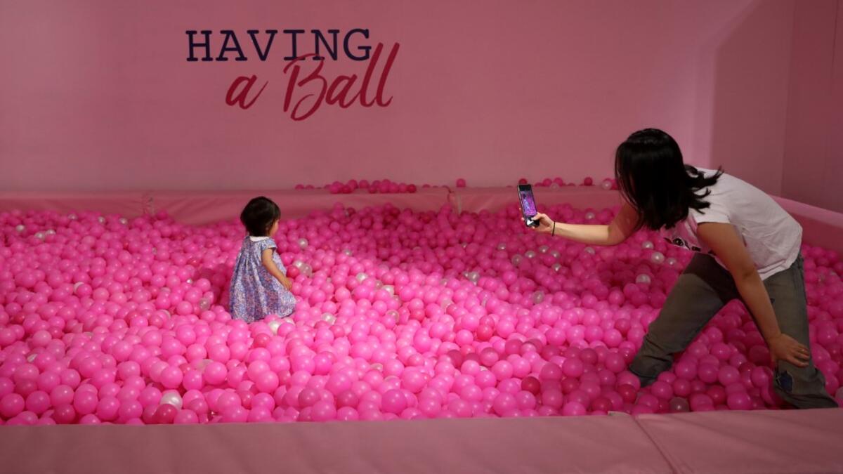 Visitors take and pose for "selfie" photographs at The Selfie Factory in Westfield London shopping centre in west London on September 11, 2019. ISABEL INFANTES / AFP