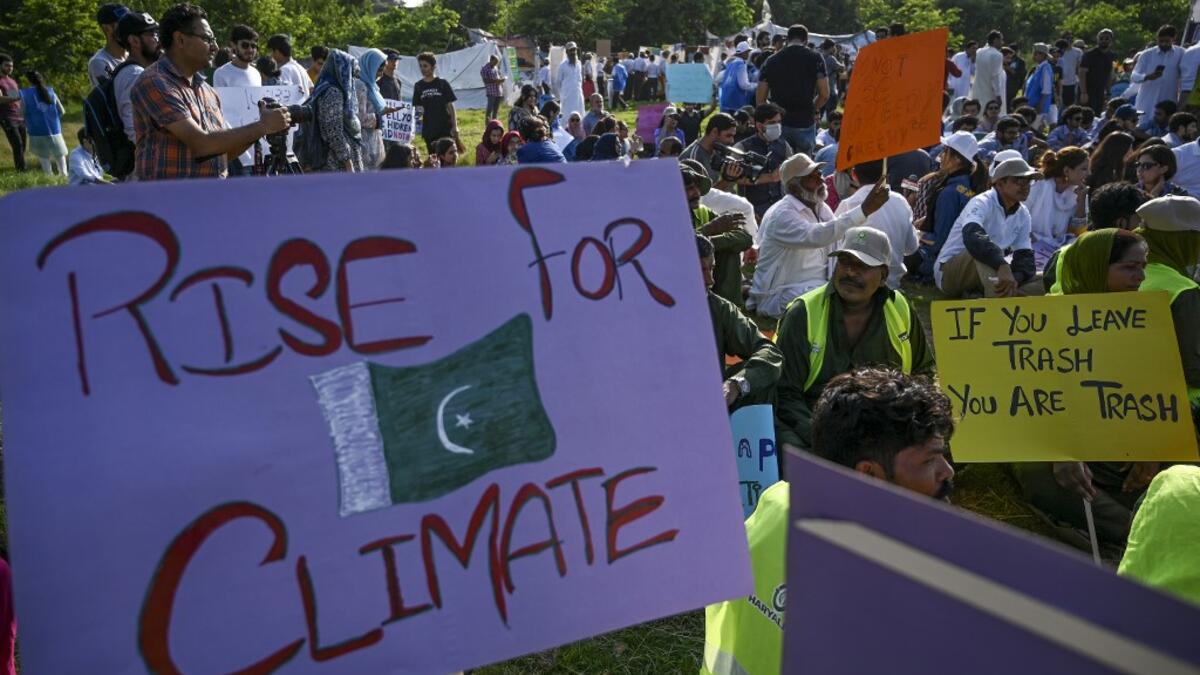 Youths hold placards as they sit during a climate strike to protest against governmental inaction towards climate breakdown and environmental pollution, part of demonstrations being held worldwide in a movement dubbed "Fridays for Future", in Islamabad on September 20, 2019. AAMIR QURESHI / AFP