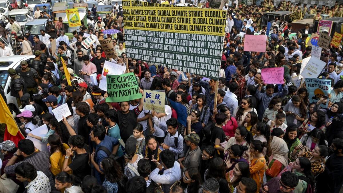 Youths hold placards as they march for a climate strike to protest against governmental inaction towards climate breakdown and environmental pollution, part of demonstrations being held worldwide in a movement dubbed "Fridays for Future", in Lahore on September 20, 2019. ARIF ALI / AFP