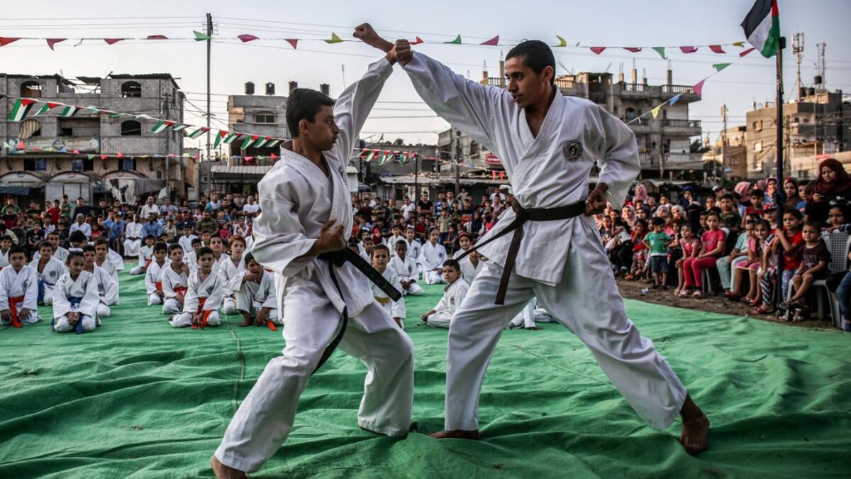 Young Palestinian karatekas demonstrate their skills during a Karate promotion ceremony at a sporting centre in the Rafah camp for Palestinian refugees in the southern Gaza Strip on September 20, 2019. SAID KHATIB / AFP