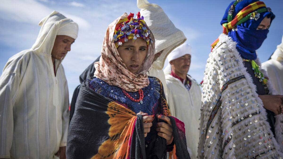 Young Amazigh (Berber) men and women take part in the the annual "Engagement Moussem" festival near the village of Imilchil in central Morocco's high Atlas Mountains on September 21, 2019. Each year in the High Atlas Mountains hamlet of Ait Amer, tribes celebrate with dance and music, the collective wedding of young Amazigh couples during the traditional festival. FADEL SENNA / AFP