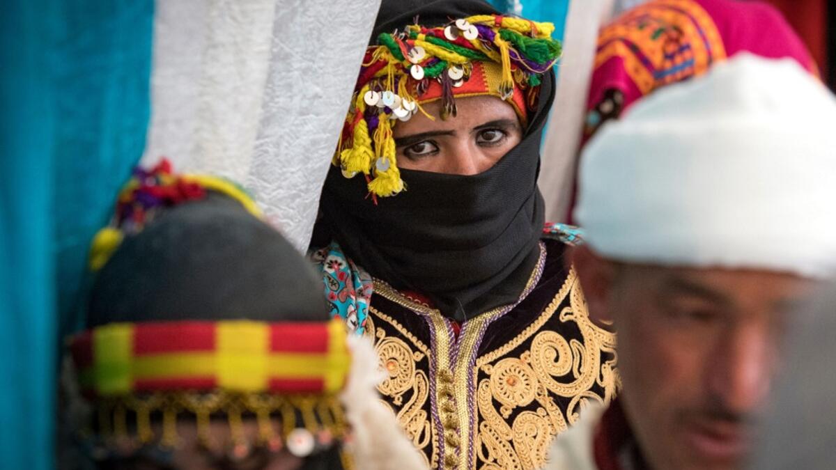 Young Amazigh (Berber) men and women wait for their wedding ceremony during the annual "Engagement Moussem" festival near the village of Imilchil in central Morocco's high Atlas Mountains on September 21, 2019. Each year in the High Atlas Mountains hamlet of Ait Amer, tribes celebrate with dances and music, the collective wedding of young Amazigh couples during the traditional festival of "Engagement Moussem". FADEL SENNA / AFP