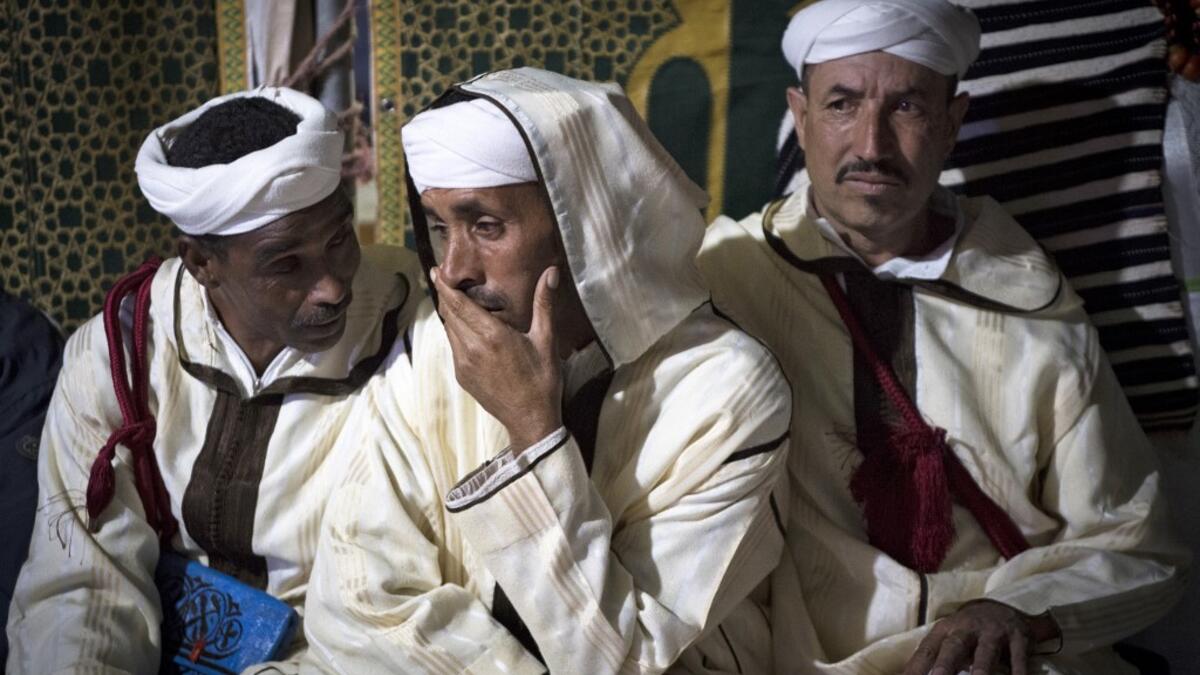Members of a traditional music group gather before performing at the annual "Engagement Moussem" festival near the village of Imilchil in central Morocco's high Atlas Mountains on September 21, 2019. Each year in the High Atlas Mountains hamlet of Ait Amer, tribes celebrate with dances and music, the collective wedding of young Amazigh couples during the traditional festival of "Engagement Moussem". FADEL SENNA / AFP