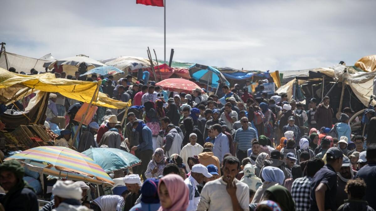 Amazigh (Berber) men and women take part in the annual "Engagement Moussem" festival near the village of Imilchil in central Morocco's high Atlas Mountains on September 21, 2019. Each year in the High Atlas Mountains hamlet of Ait Amer, tribes celebrate with dances and music, the collective wedding of young Amazigh couples during the traditional festival of "Engagement Moussem". FADEL SENNA / AFP