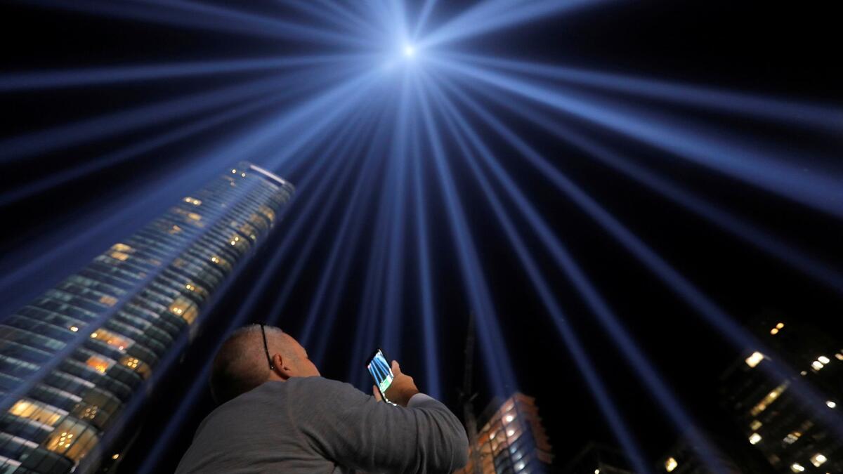 People look toward the Tribute in Light, lit up to commemorate the 18th anniversary of the September 11, 2001 attacks in New York, on Tuesday (Twitter)