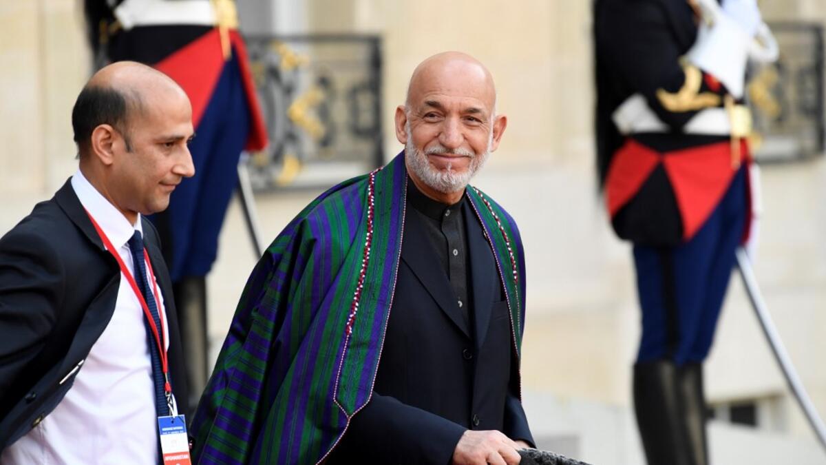 Former Afghan President Hamid Karzai (C) gestures as he leaves The Elysee Presidential Palace in Paris on September 30, 2019, following a luncheon after a church service for former French President Jacques Chirac. Former French President Jacques Chirac died on September 26, 2019 at the age of 86. Bertrand GUAY / AFP