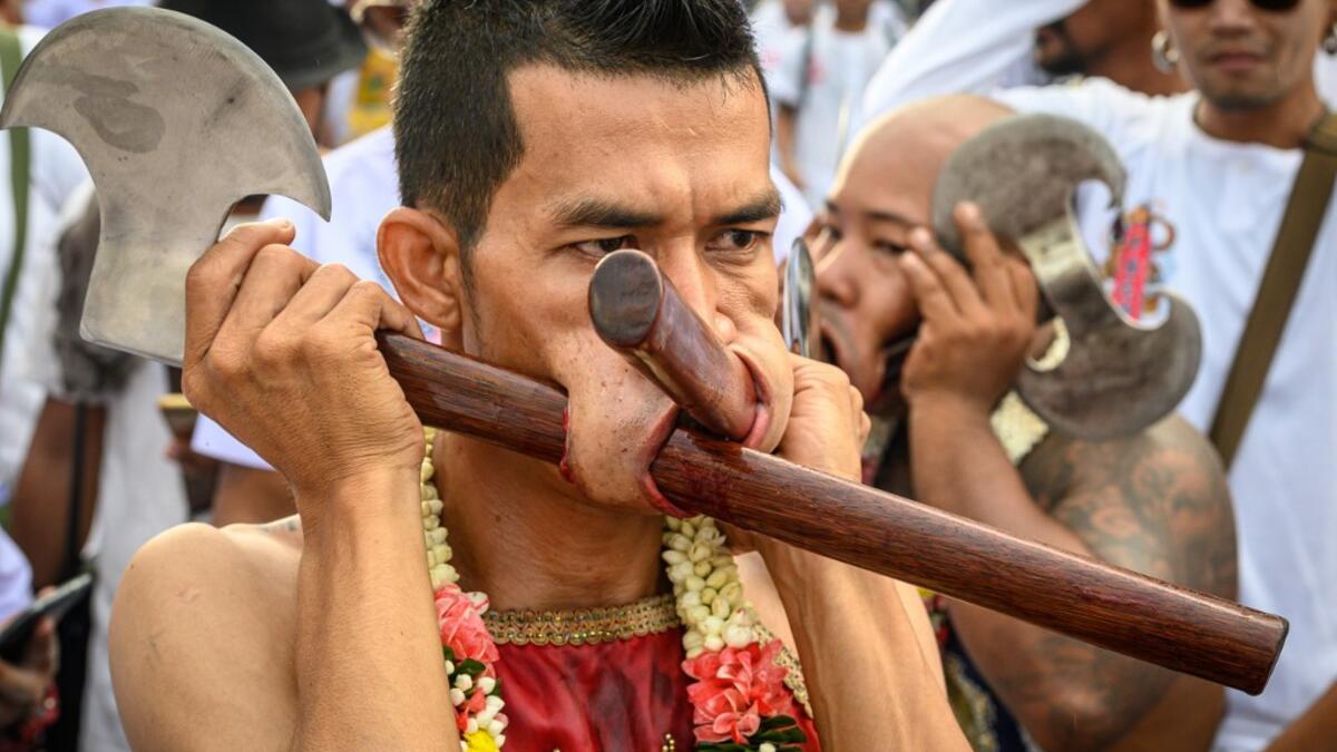 The festival begins on the first evening of the ninth lunar month and lasts for nine days, with many religious devotees slashing themselves with swords, piercing their cheeks with sharp objects and committing other painful acts to purify themselves, taking on the sins of the community. Mladen ANTONOV / AFP
