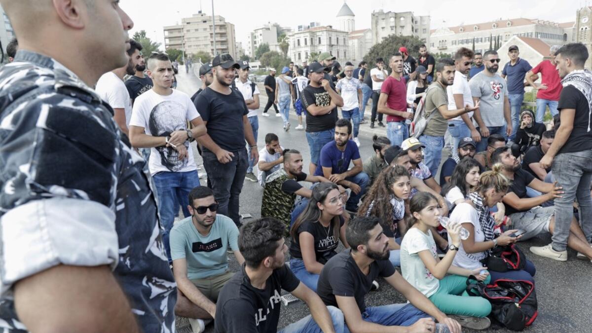 Lebanese protesters try to block a road during a demonstration near central Beirut's Martyr Square on October 6, 2019. Lebanese protested in the capital over increasingly difficult living conditions, amid fears of a dollar shortage and possible price hikes. ANWAR AMRO / AFP