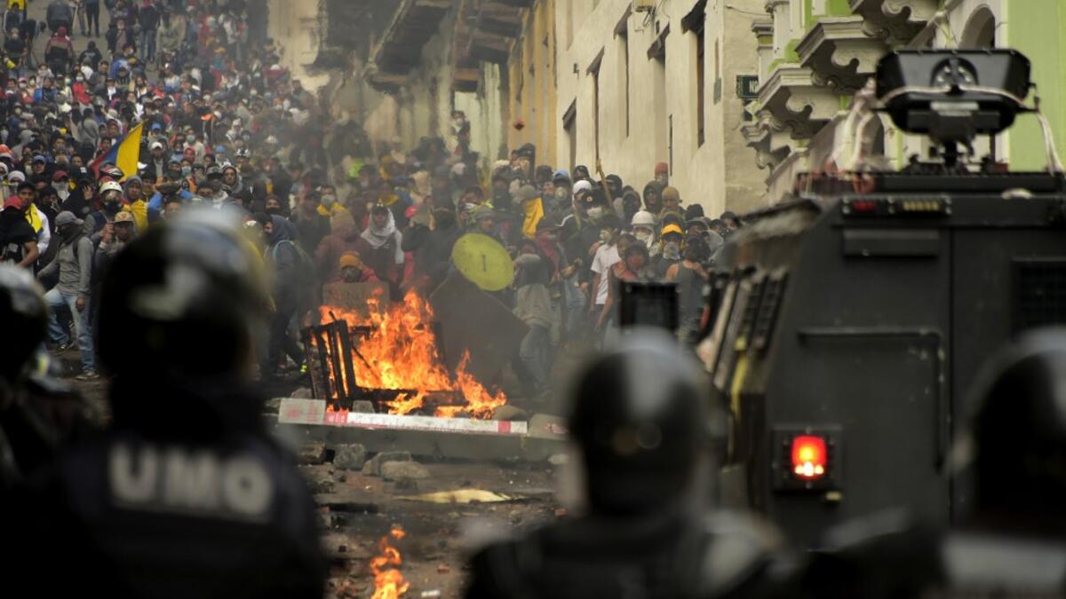 Demonstrators clash with riot police in Quito on October 9, 2019, on the second day of violent protests over a fuel price hike ordered by the government to secure an IMF loan. The violence broke out as thousands of people representing indigenous groups, farmers and labour unions marched on a square in downtown Quito near the government headquarters demanding that Moreno reinstate fuel subsidies. RODRIGO BUENDIA / AFP