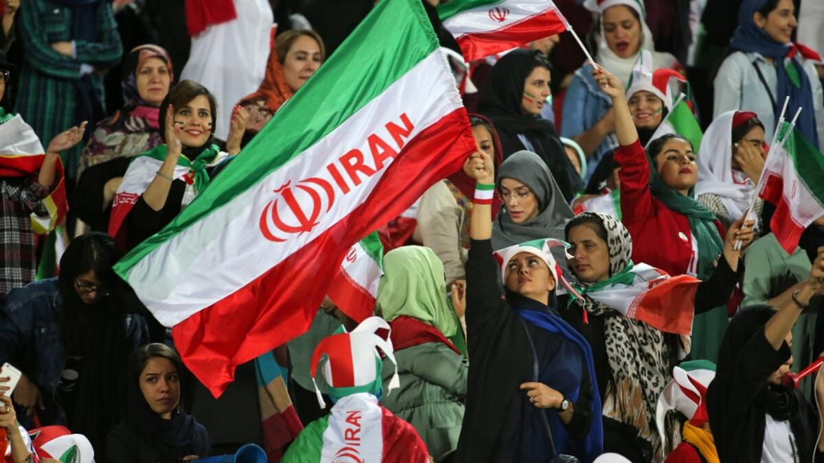 The Islamic republic has barred female spectators from football and other stadiums for around 40 years, with clerics arguing they must be shielded from the masculine atmosphere and sight of semi-clad men. Women fans are attending the football match freely for the first time in decades, after FIFA threatened to suspend the country over its controversial male-only policy.  ATTA KENARE / AFP