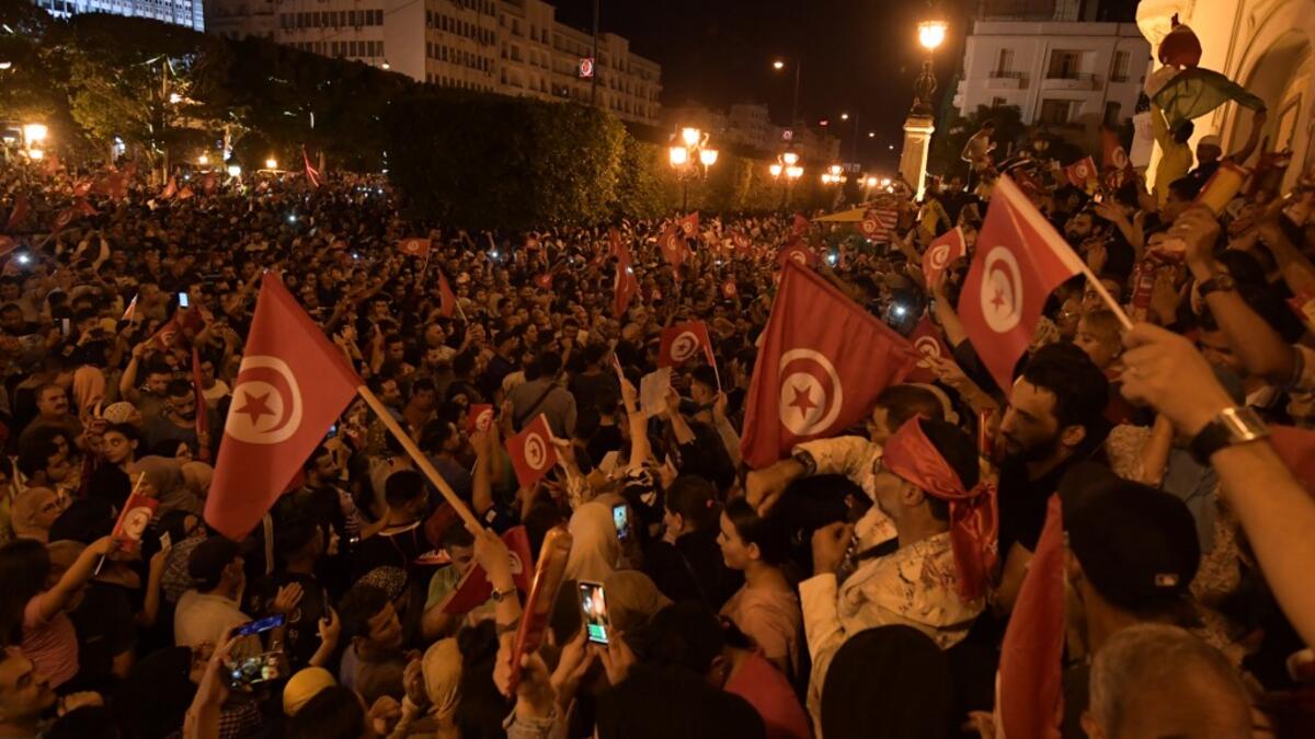 Tunisians gather to celebrate the victory of Kais Saied in the Tunisia's presidential runoff on October 13, 2019, in the capital Tunis. Conservative academic Kais Saied, a political outsider, won a landslide victory Sunday in Tunisia's presidential runoff, sweeping aside his rival, media magnate Nabil Karoui, state television said. Fethi Belaid / AFP