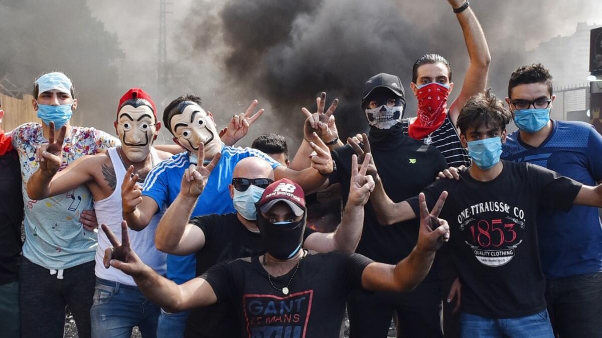 Lebanese protesters block a main road near Beirut-Rafic Hariri International Airport, amidst ongoing protests against dire economic conditions, on October 18, 2019. Public anger has simmered since parliament passed an austerity budget in July to help trim a ballooning deficit and flared on October 17 over new plans to tax calls on messaging applications such as WhatsApp, forcing the government to axe the unpopular proposal. AFP