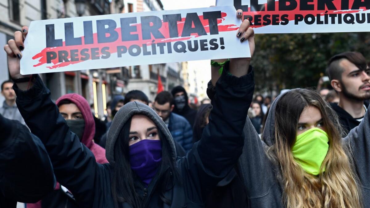 Protesters hold banners reading in Catalan "Freedom for politic prisoners!" during a pro-amnesty demonstration called by Madrid's Anti-repression Movement and demanding total amnesty and the defence of democratic rights and freedoms in Madrid on October 19, 2019. AFP