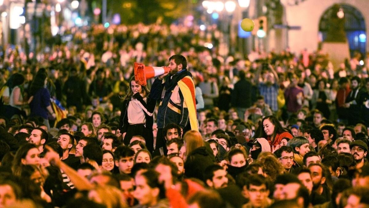 A demonstrator uses a traffic cone as megaphone during a protest in front of the Spanish national police headquarters in Barcelona on October 20, 2019. Nearly 600 people have been injured in clashes with police since the protests started in Catalonia. Demonstrators have set fire to cars and garbage bins and thrown rocks at police, who have responded by using their batons and firing rubber bullets. JOSE JORDAN / AFP