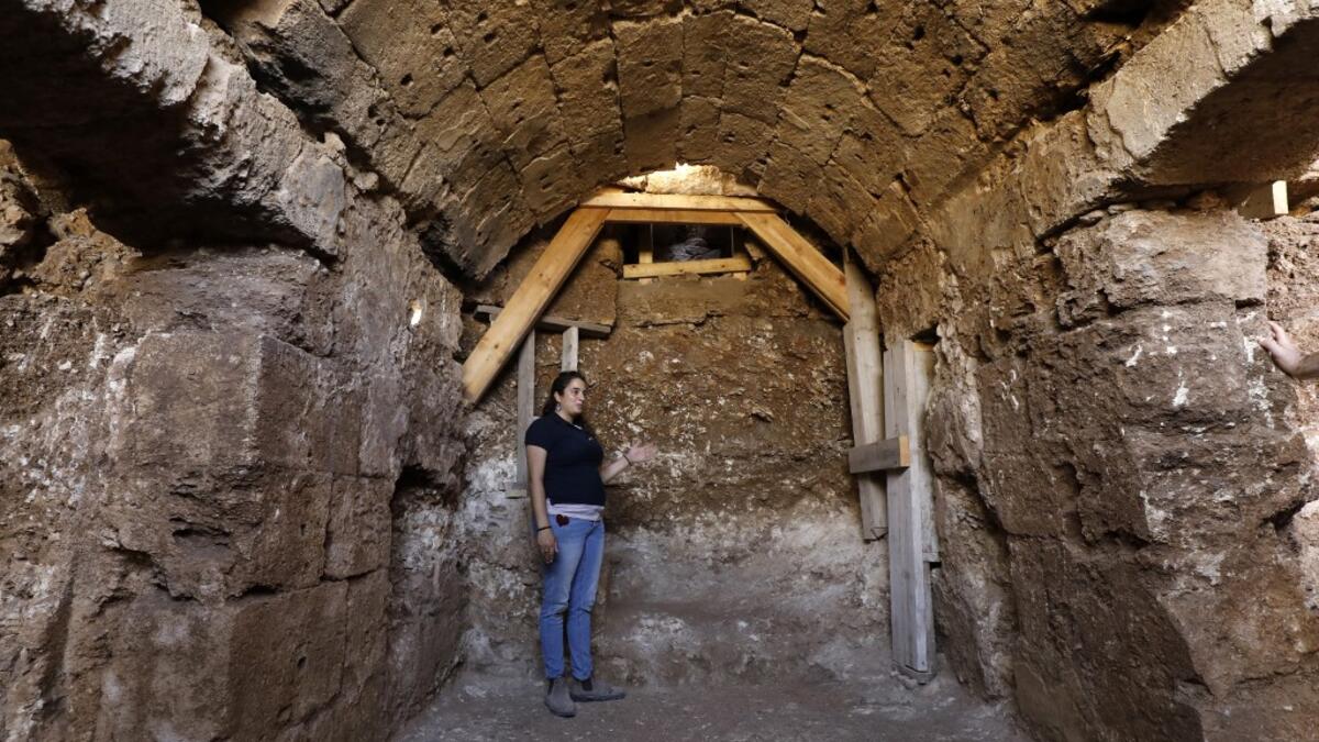 Timnah Goloubin, an archaeologist with the Israel Antiquities Authority, shows on October 23, 2019 the ancient church crypt in the Israeli city of Bet Shemesh. A magnificent 1500-year-old church, decorated with spectacular mosaic floors and Greek inscriptions, was discovered during a three-year excavation near a residential area. MENAHEM KAHANA / afp