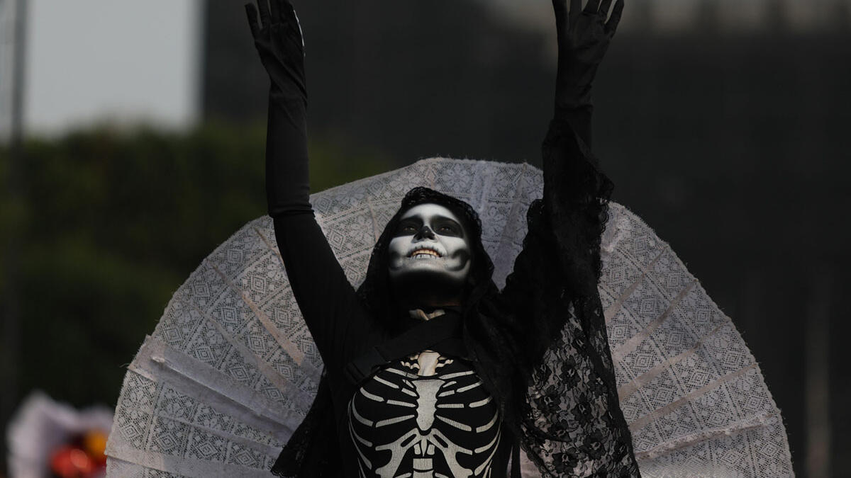 A costumed participant walks in the annual International Day of the Dead Parade in Mexico City  Emilio Espejel / Anadolu Agency / Getty