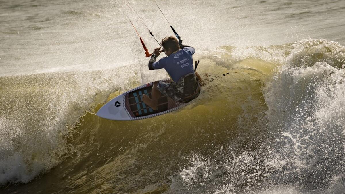 A picture taken on October 10, 2019, shows a kitesurfer riding waves at Dakhla beach in Morocco-administered Western Sahara. In the heart of disputed Western Sahara, a former garrison town has become an unlikely tourist magnet after kitesurfers discovered the windswept desert coast on the Atlantic is perfect for their sport. FADEL SENNA / AFP
