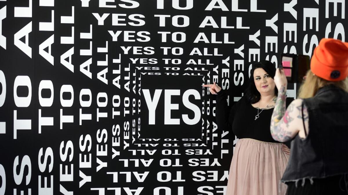 A woman is being photographed at the "Supercandy Pop-Up Museum Vol. 2" in Cologne, western Germany on November 1, 2019. It is an interactive museum and offers a photo backdrop for social media at 25 stations. INA FASSBENDER / AFP