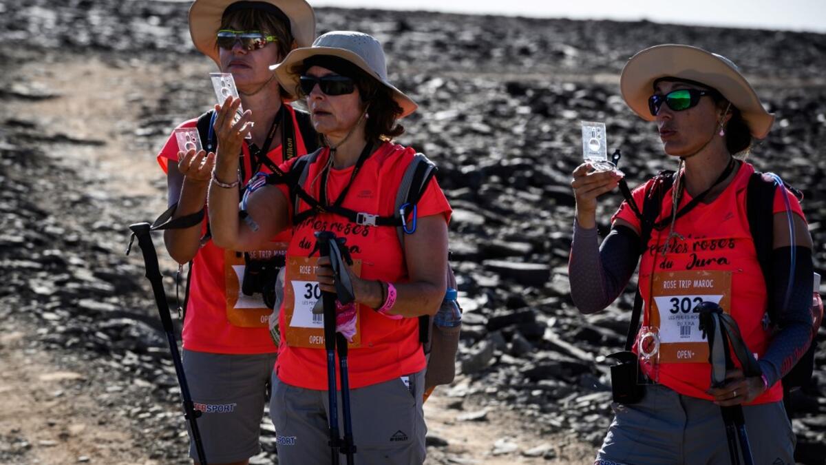Women take part in the desert trek "Rose Trip Maroc", on November 3, 2019 in the erg Chebbi near Merzouga. The Rose Trip Maroc is a female-oriented trek where teams of three must travel through the southern Moroccan Sahara desert with a compass, a map and a topographical reporter. JEAN-PHILIPPE KSIAZEK / AFP