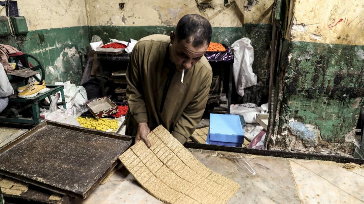 An Egyptian confectioner shows bars of sweets with sesame at a candy factory in the capital Cairo on November 2, 2019, ahead of celebrations of the Muslim Prophet Mohammed's birthday, known as "Al Mawlid Al Nabawi". Prophet Mohamed was born in Saudi Arabia's arid mountainous city of Mecca, the holiest in Islam, some 1490 years ago. Sunni Muslims in many parts of the world celebrate his birthday on the 12th day of the third month of the Islamic calendar, which will fall this year on November 9th.  Mohamed el