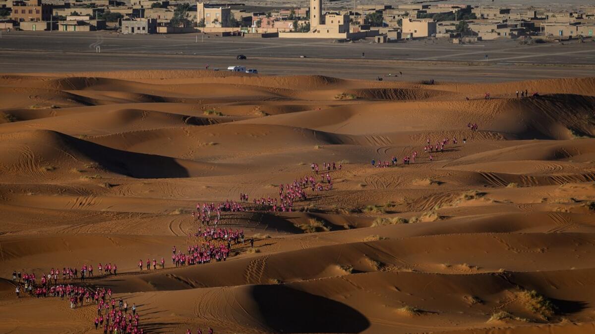Women take part in the desert trek "Rose Trip Maroc", on November 4, 2019 in the erg Chebbi near Merzouga. The Rose Trip Maroc is a female-oriented trek where teams of three must travel through the southern Moroccan Sahara desert with a compass, a map and a topographical reporter. JEAN-PHILIPPE KSIAZEK / AFP