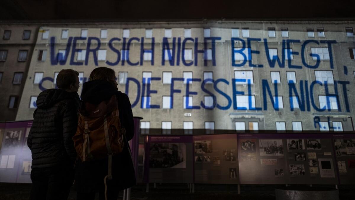 A giant banner reading: "He who does not move can not feel his restraints" is projected on the walls of the former Stasi (Former east German secret police) headquarters during the city-wide kick-off of the festival week to celebrate the 30th anniversary of the November 9,1989 fall of the Berlin Wall, in Berlin on November 4, 2019. Germany marks three decades since the fall of the Berlin Wall this week with main celebrations on November 9, 2019. John MACDOUGALL / AFP