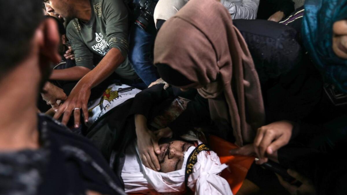 Palestinian relatives of Islamic Jihad militant Abdullah al-Belbasi mourn during his funeral in Beit Hanun in the northern Gaza Strip on November 13, 2019. Two more Palestinians were killed in an Israeli strike in the Gaza Strip, the enclave's health ministry said, as Israel said it was targeting rocket-launching squads and militant sites. The deaths brought the Gaza toll to 18 people killed since an exchange of fire began on Tuesday with an Israeli targeted strike on an Islamic Jihad commander sparking ret