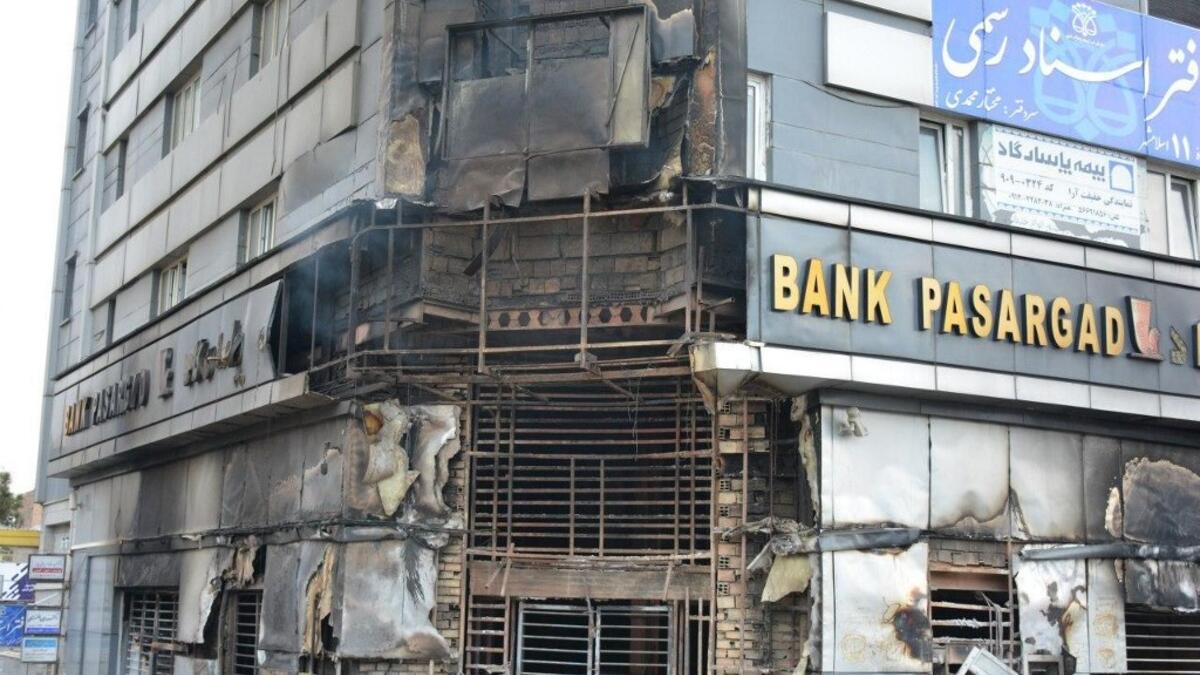 A picture taken on November 17, 2019 shows a scorched branch of Iranian Pasargad bank that was set ablaze by protesters during a demonstration against a rise in gasoline prices in Eslamshahr, near the Iranian capital of Tehran.  AFP