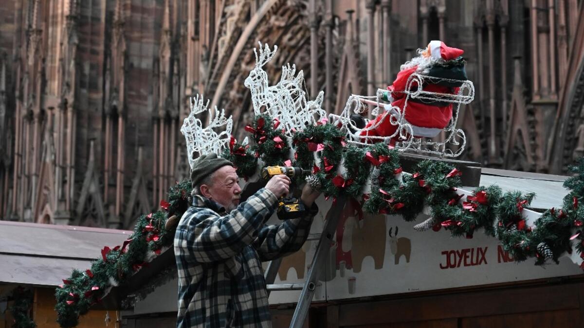 A worker installs the traditional Christmas market in Strasbourg, eastern France, on November 18, 2019, one year after the deadly attack, as the Christmas market of the city will open on November 22. PATRICK HERTZOG / AFP