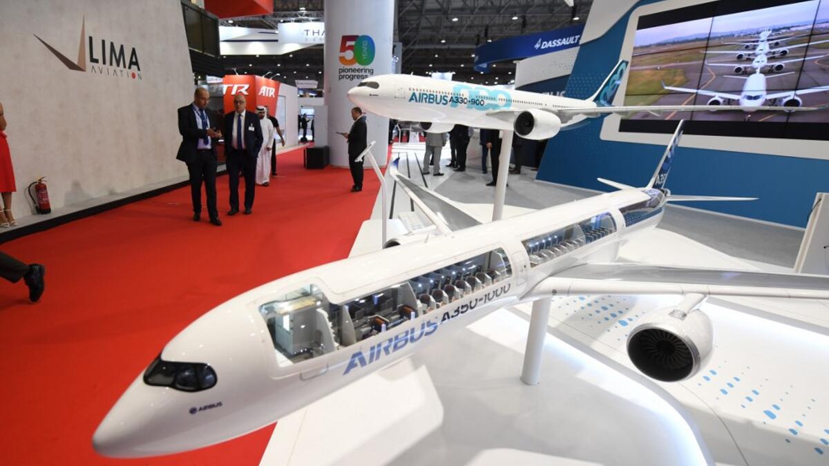 Models of an Airbus 350 and Airbus 330 are displayed during the Dubai Airshow in Dubai on November 19, 2019. Emirates Airline said it will buy 50 Airbus 350-900 aircraft in a deal worth $16 billion, with delivery to begin from May 2023. KARIM SAHIB / AFP