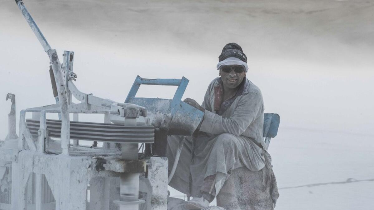 Covered in fine white dust, labourers at the so-called "White Mountain" off Minya toil in shifts amidst brutal conditions with little workplace safety for paltry pay. They handle dangerous machinery with finesse, and shrug off the dangers of a job where a mistake can prove fatal. Khaled DESOUKI / AFP