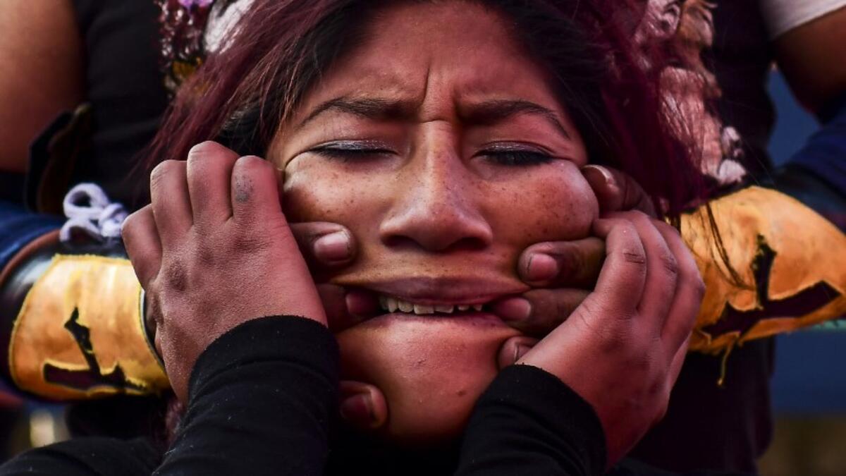 Bolivian wrestler Blanca Perez, aka "Katy The Beautiful", a member of the Fighting Cholitas, fights with a male wrestler at Sharks of the Ring wrestling club in El Alto, Bolivia, on November 24, 2019. After a fortnight hiatus due to anti-government protests and blockades, the Fighting Cholitas are back in the ring. The unrest was triggered by the disputed October 20 election, which Evo Morales claimed to have won and opposition groups said was rigged. Ronaldo SCHEMIDT / AFP