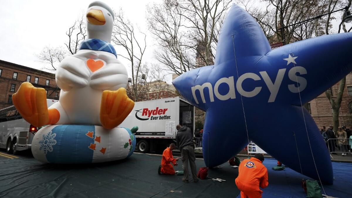 The Aflac Duck and Macys balloon are pictured during the Macy's Thanksgiving Day Parade balloon inflation in New York City on November 27, 2019, offering spectators the chance to see the giant balloons being inflated ahead of tomorrow's Parade. Macy's and NYPD will make a decision tommorow on the fate of the balloons due to high winds in the forecast. TIMOTHY A. CLARY / AFP