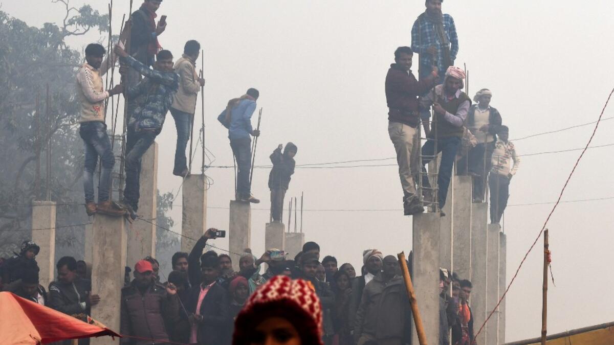 People watch Hindu devotee slaughter buffalos as offering during the Gadhimai Festival in Bariyarpur on December 3, 2019. Thousands of Hindu devotees gathered in southern Nepal for a festival believed to be the world's biggest ritual animal slaughter, despite court orders and calls by animal activists to end the event. The sacrifices take place every five years in Bariyarpur village close to the Indian border, in honour of the Hindu goddess of power. Prakash MATHEMA / AFP