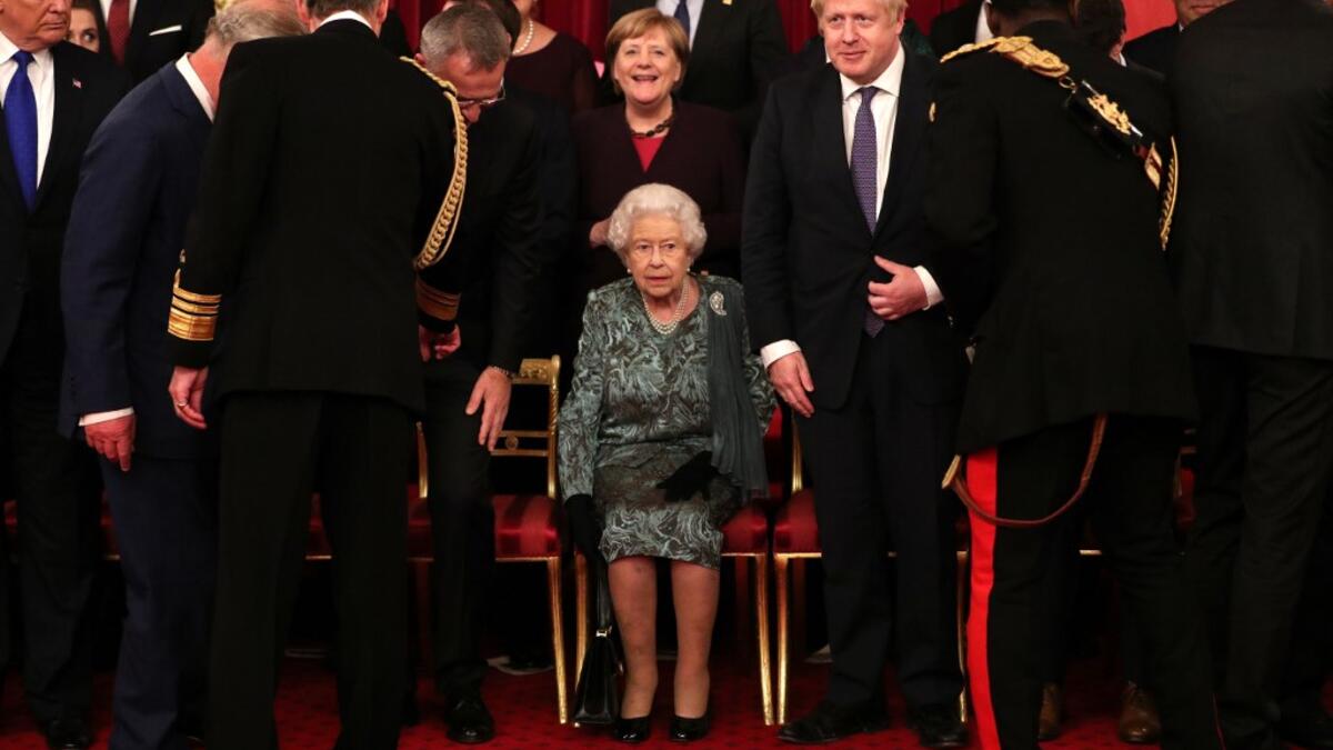 Britain's Queen Elizabeth II (C) sits as leaders come together at Buckingham Palace in central London on December 3, 2019, for a group picture to mark 70 years of the alliance ahead of the NATO alliance summit. NATO leaders gather Tuesday for a summit to mark the alliance's 70th anniversary but with leaders feuding and name-calling over money and strategy, the mood is far from festive. Yui Mok / POOL / AFP