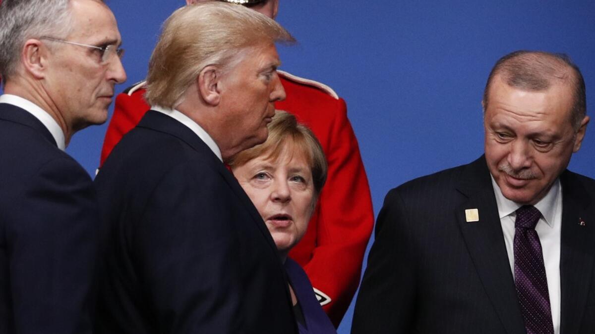 (L-R) NATO Secretary General Jens Stoltenberg, US President Donald Trump, German Chancellor Angela Merkel and Turkey's President Recep Tayyip Erdogan leave the stage after the family photo to head to attend the plenary session of the NATO summit at the Grove hotel in Watford, northeast of London on December 4, 2019. Adrian DENNIS / AFP
