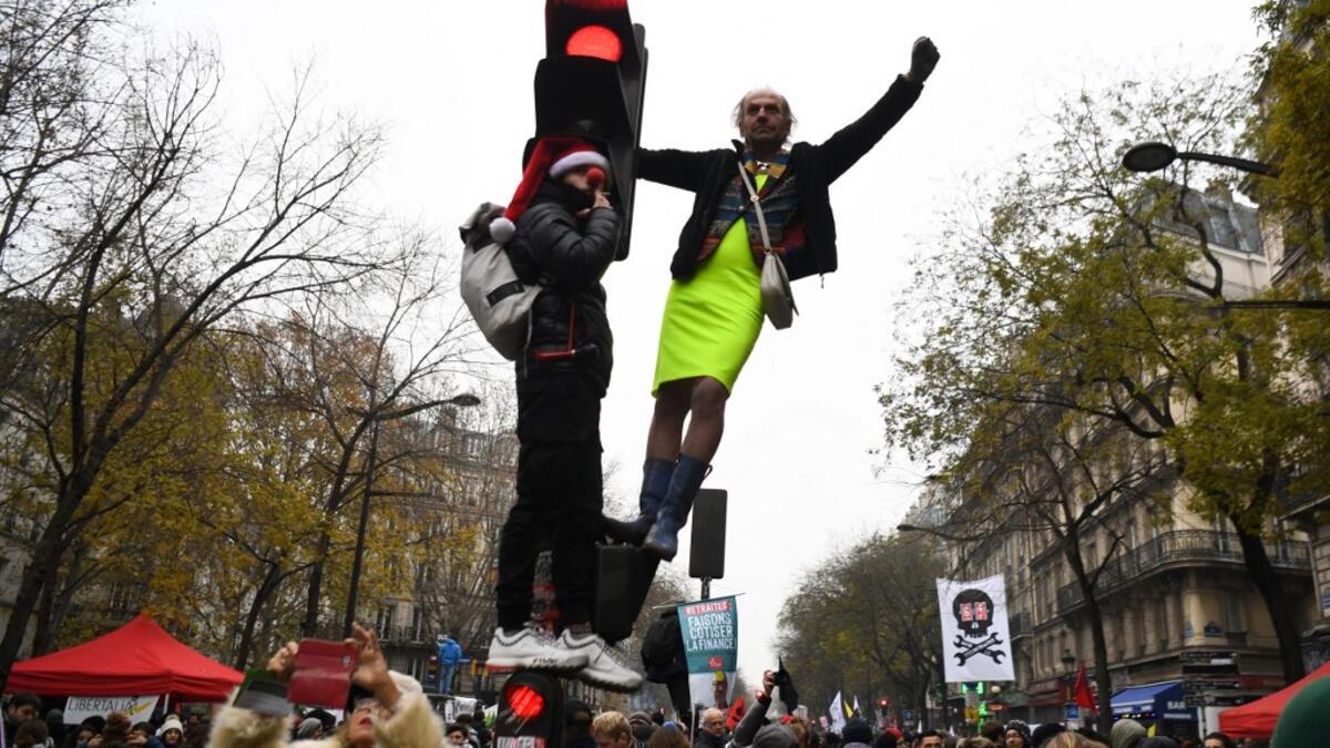 Protesters take part in a demonstration against the pension overhauls, on Place de la Nation in Paris, on December 5, 2019, as part of a national general strike. Trains cancelled, schools closed: France scrambled to make contingency plans on for a huge strike against pension overhauls that poses one of the biggest challenges yet to French President's sweeping reform drive. Alain JOCARD / AFP