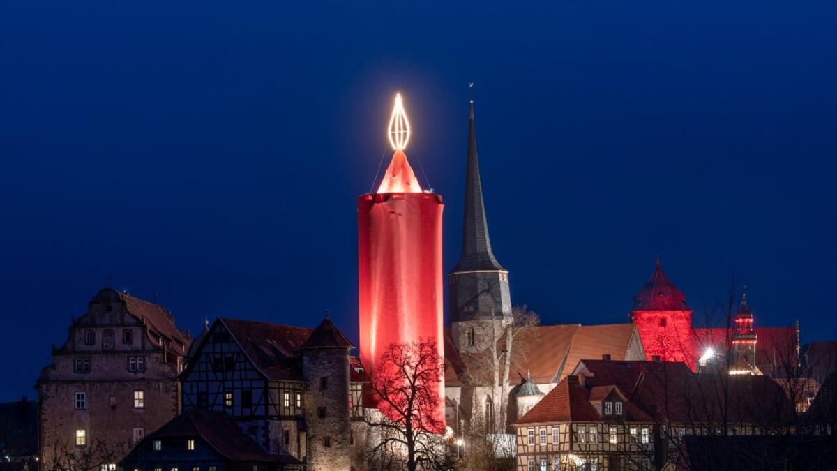 A picture taken on December 7, 2019 shows a tower made up as a giant candle in Schlitz, central Germany, as part of the Christmas celebrations. Boris Roessler / dpa / AFP